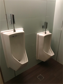 Two urinals in a bathroom, not five feet apart